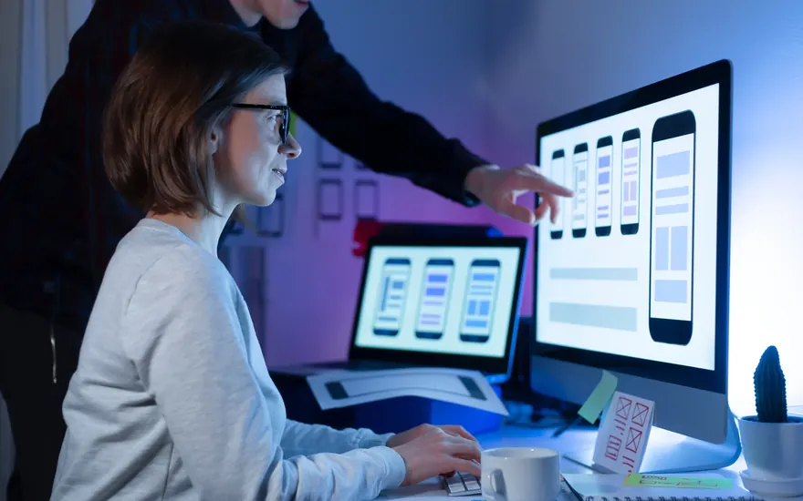 Manual testing team reviewing UI and UX designs on screen