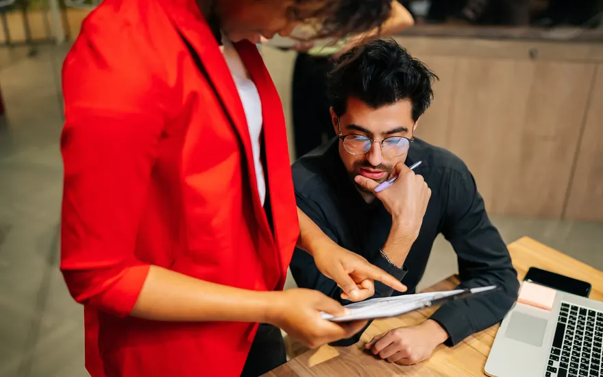 Test manager reviewing plans and checklists with a colleague