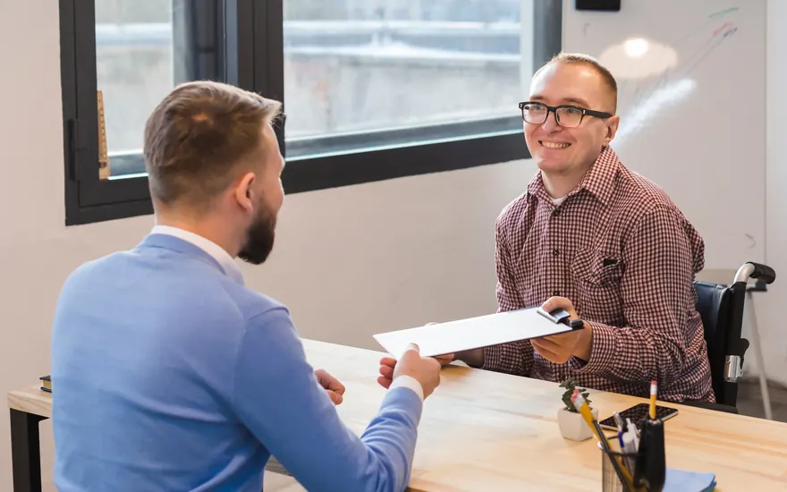 Permanent placement consultant handing over a candidate profile