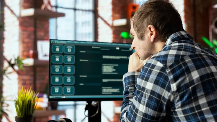 Automation tester reviewing a software dashboard on screen